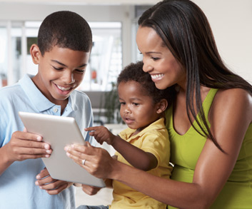 mother sharing information with children on a tablet